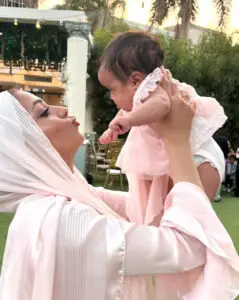 Mother holding her newborn up in the air