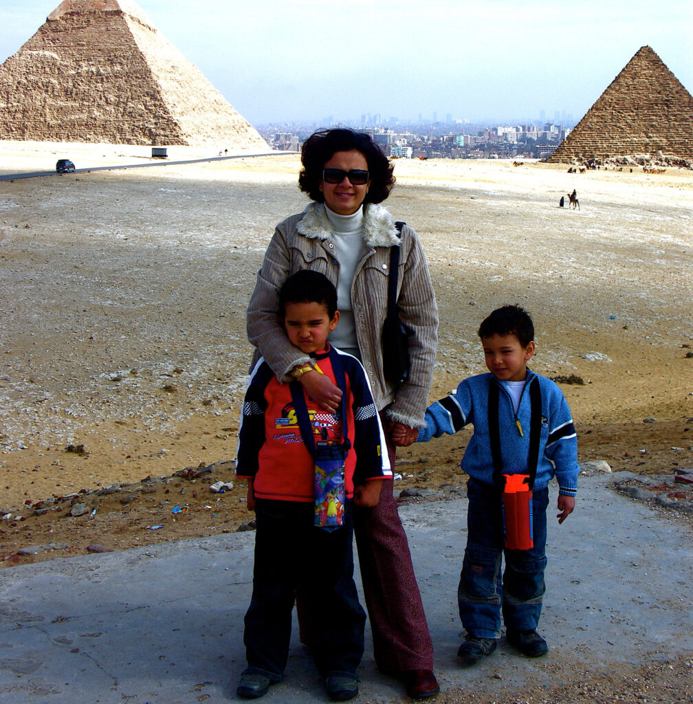 Mom holding the hands of her kids.
