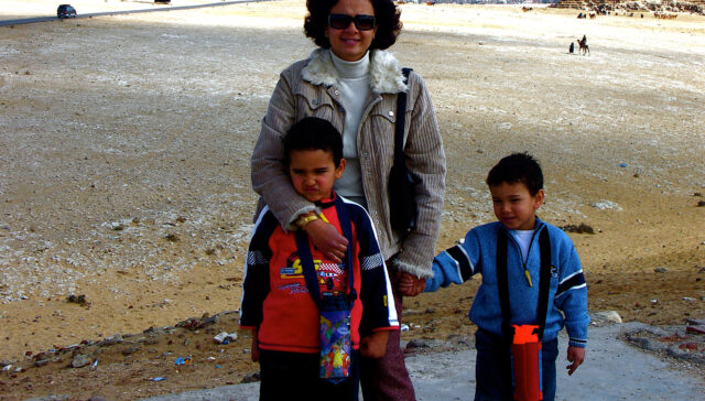 Mom holding the hands of her kids.