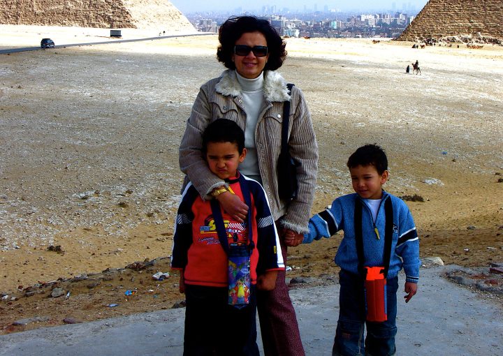 Mom holding the hands of her kids.