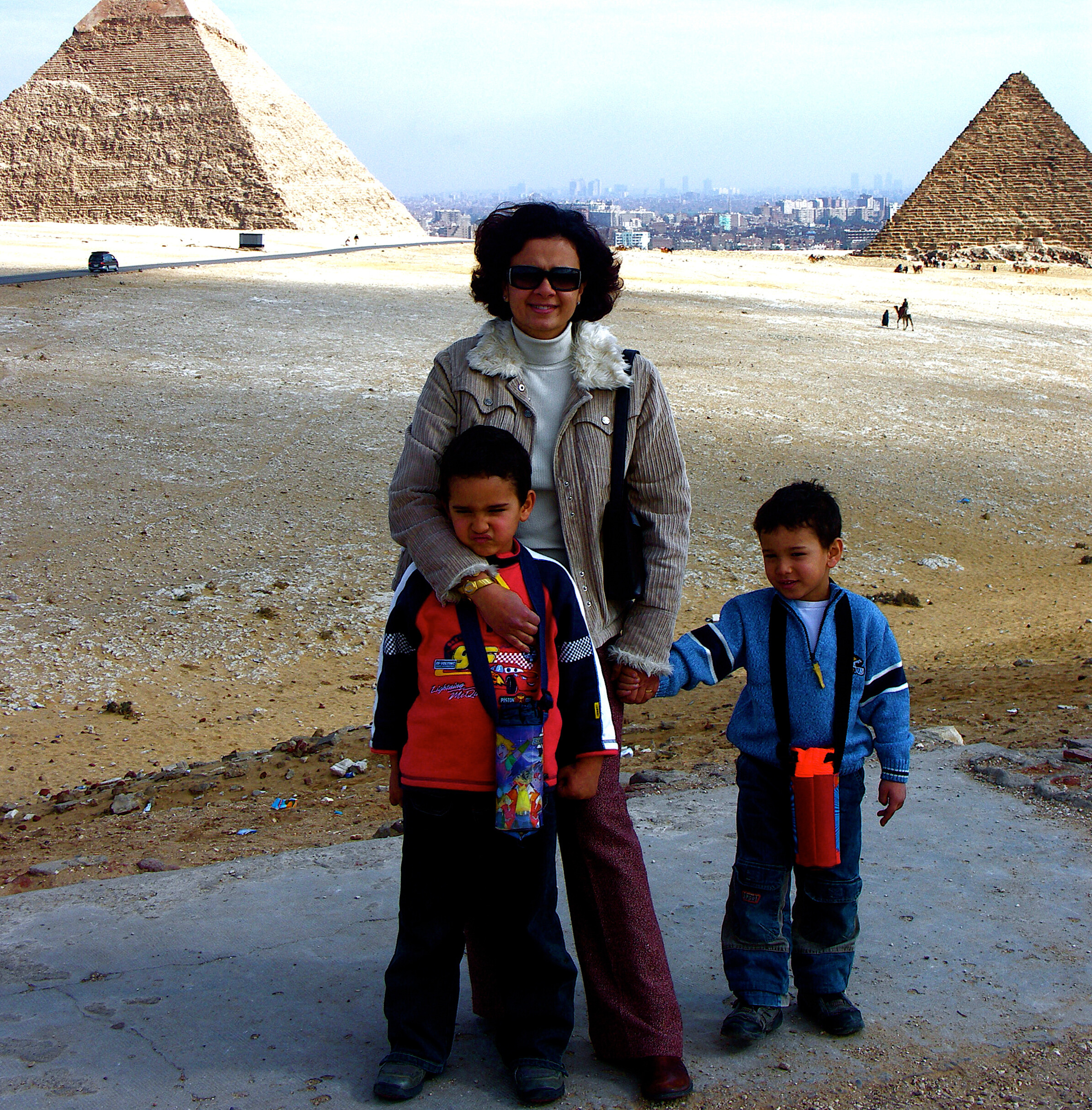 Mom holding the hands of her kids.
