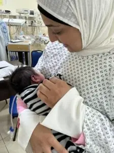Mother holding her baby in the NICU