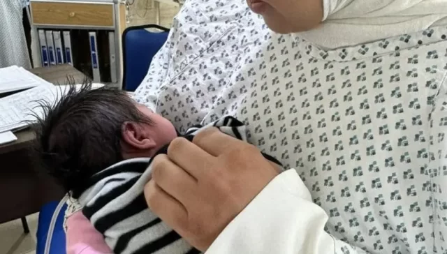 Mother holding her baby in the NICU