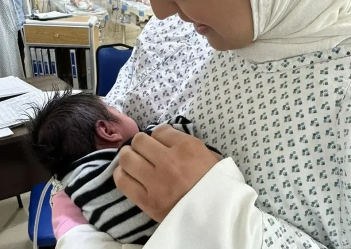 Mother holding her baby in the NICU