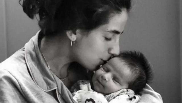 Mommy kissing newborn