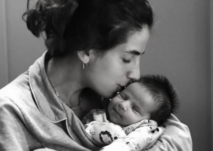 Mommy kissing newborn