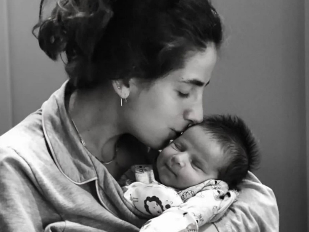 Mommy kissing newborn